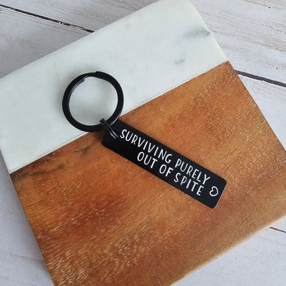 Surviving Purely Out Of Spite Black Aluminum Keychain, Lightweight Funny Hand Stamped Key Chain