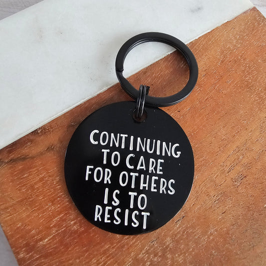 Continuing To Care For Others Is To Resist, Hand Stamped Black Metal Keychain, Antifa Gifts
