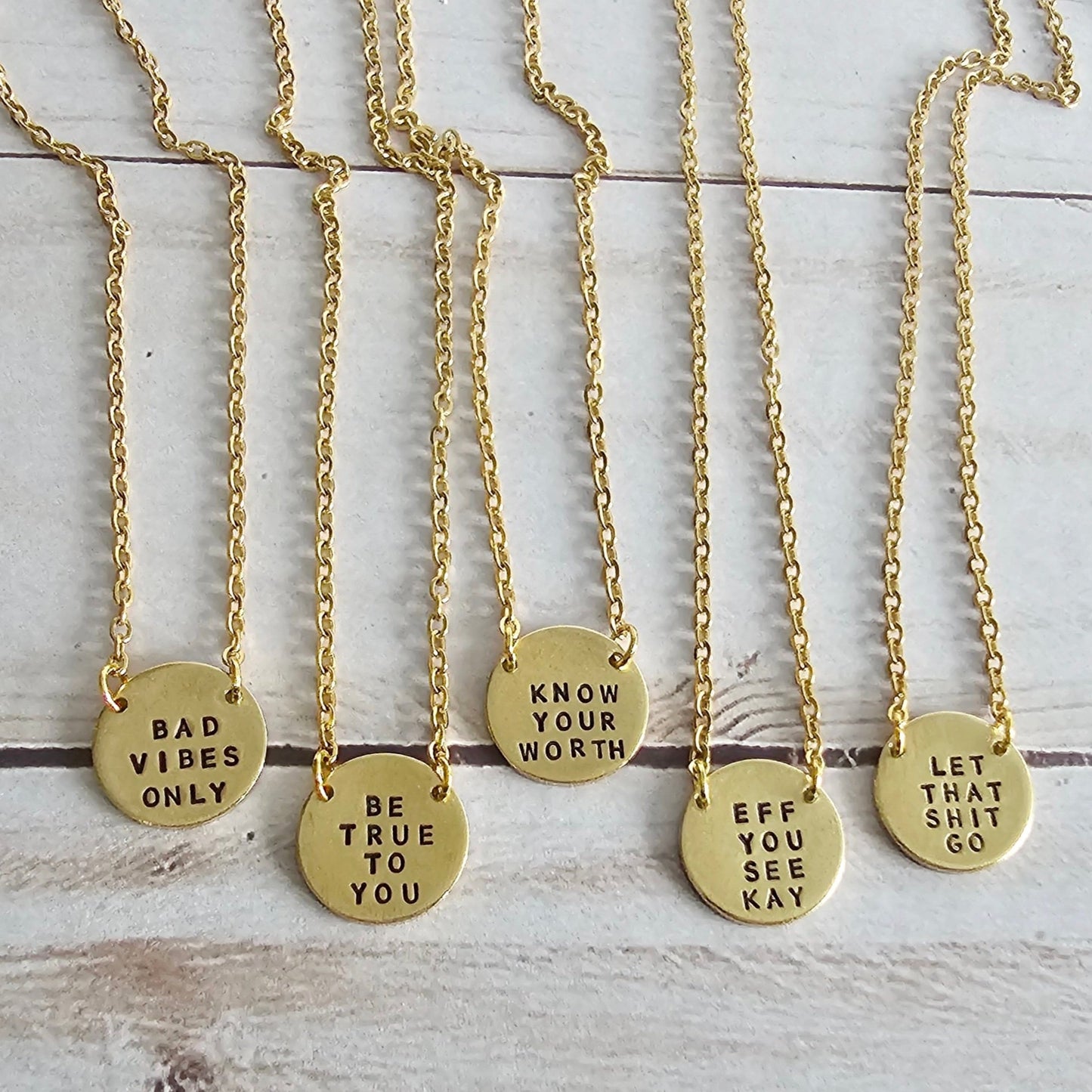 Tiny Brass Disc neckaces hand stamped with positive and funny quotes