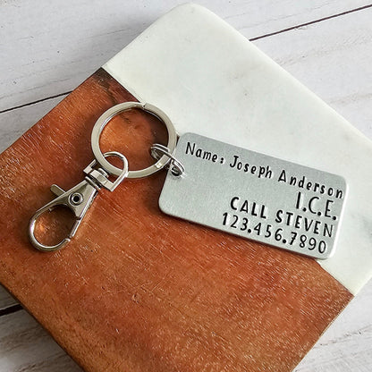 Silver rectangular keychain with Name, ICE, and emergency contact info