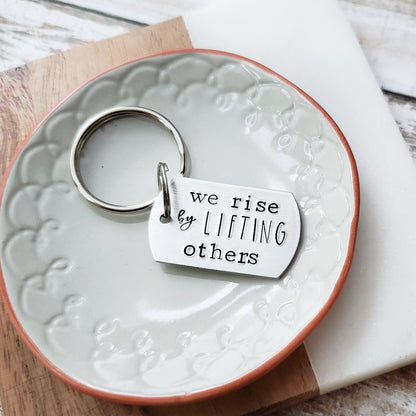 We Rise By Lifting Others Keychain