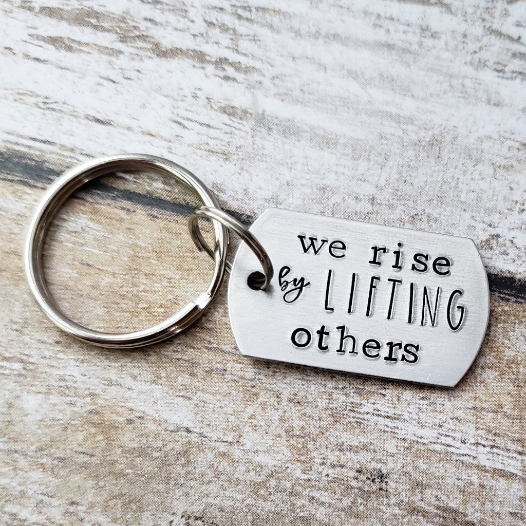 We Rise By Lifting Others Keychain
