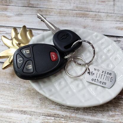 We Rise By Lifting Others Keychain