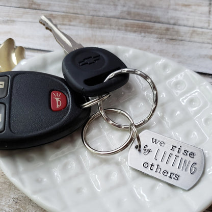 We Rise By Lifting Others Keychain