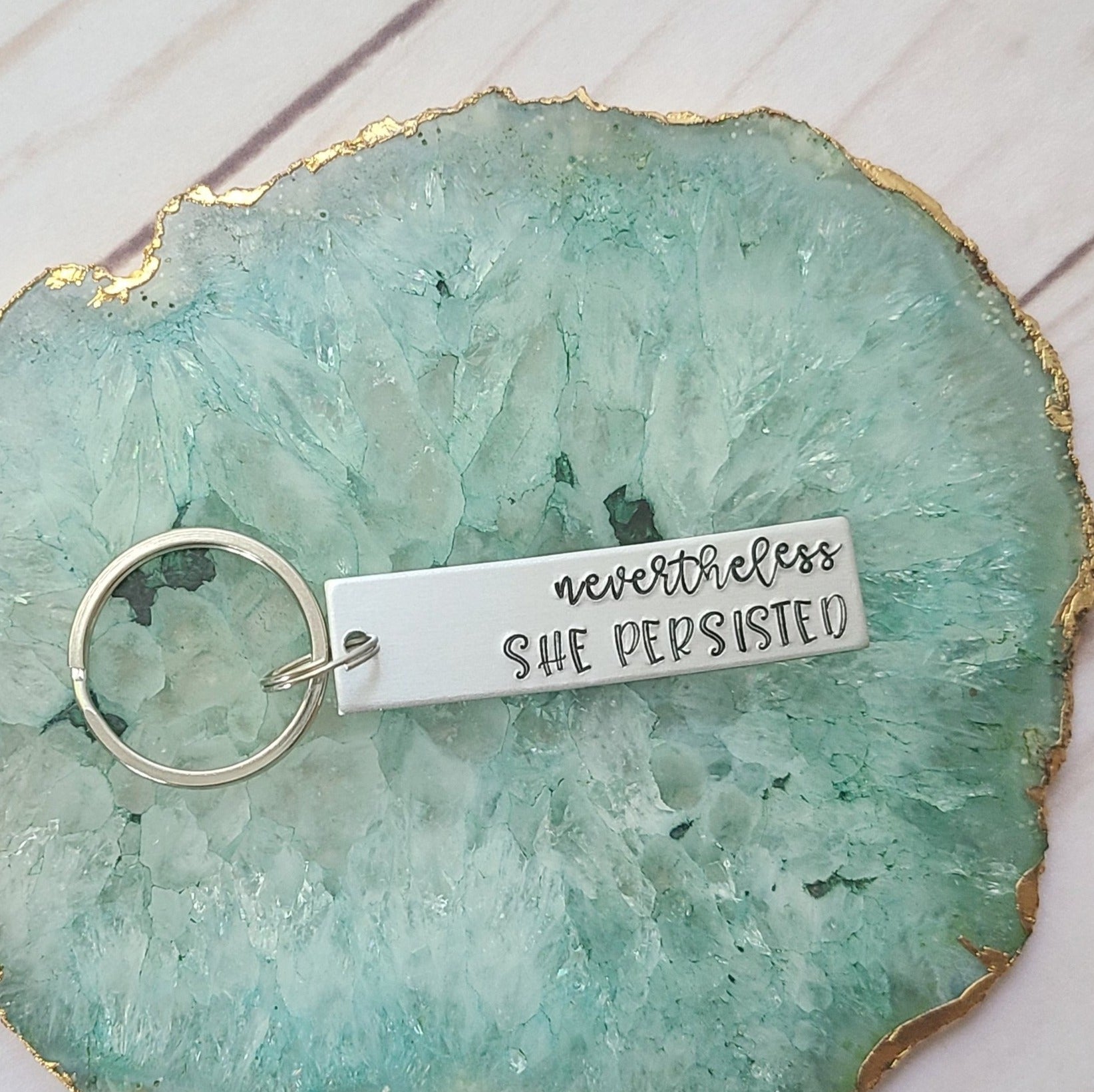 nevertheless she persisted stamped into a rectangle metal tag