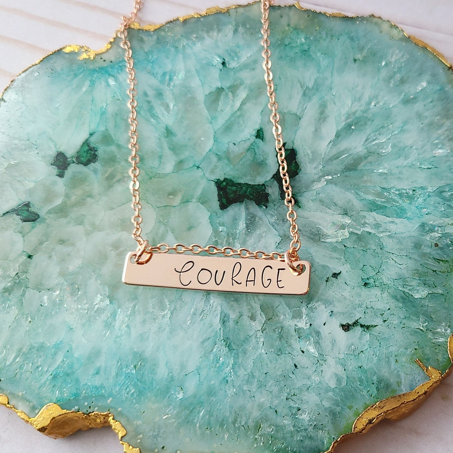 Rose Gold Plated Hand Stamped Necklace with the Word Courage Stamped on It