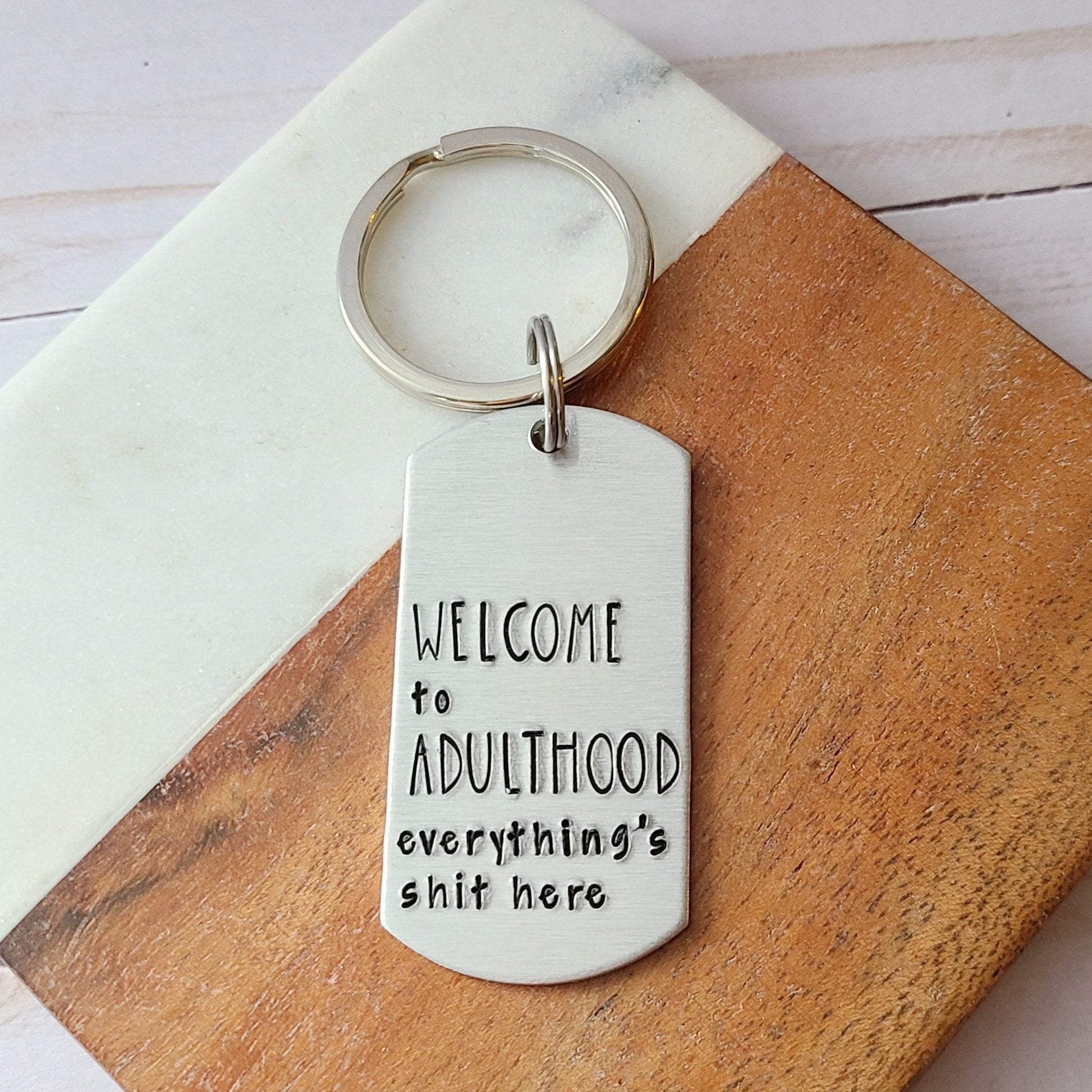 Silver Keychain Stamped to Read Welcome to Adulthood Everything's Shit Here