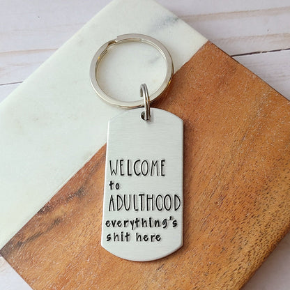 Silver Keychain Stamped to Read Welcome to Adulthood Everything's Shit Here
