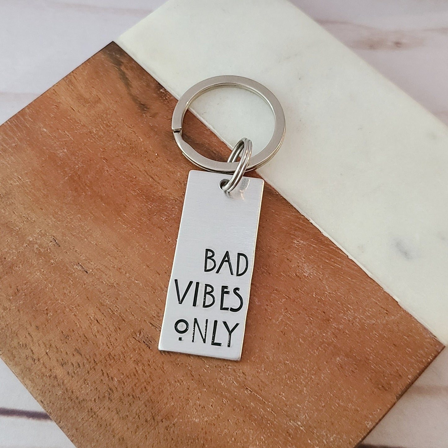 Silver Rectangle Keychain that Reads Bad Vibes Only