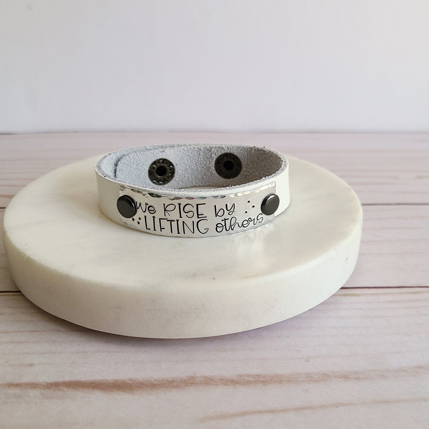 We Rise By Lifting Others - White Leather Cuff Bracelet