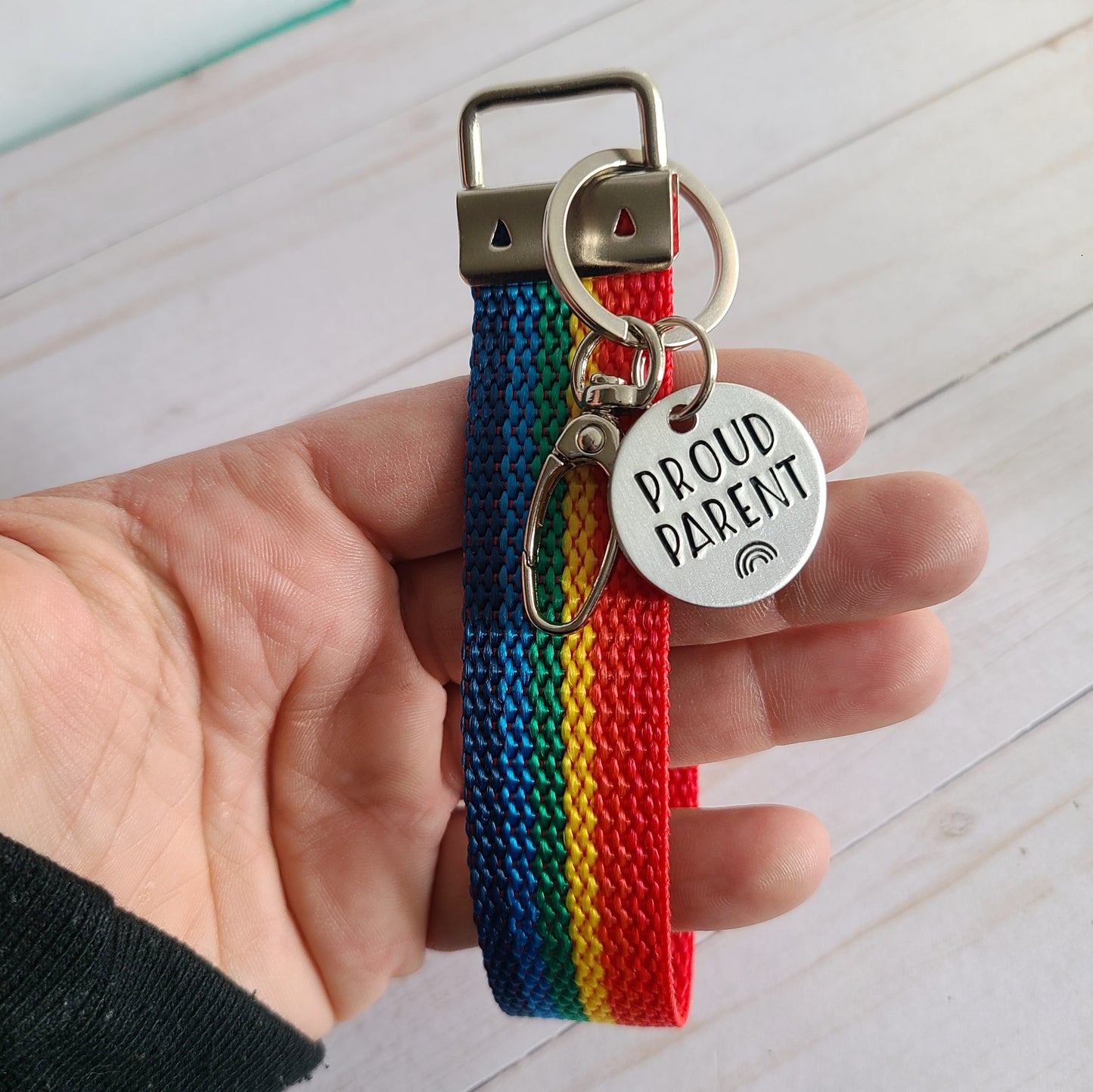 Rainbow Wristlet Keychain with a round stamped disc that reads proud parent with an image of a rainbow