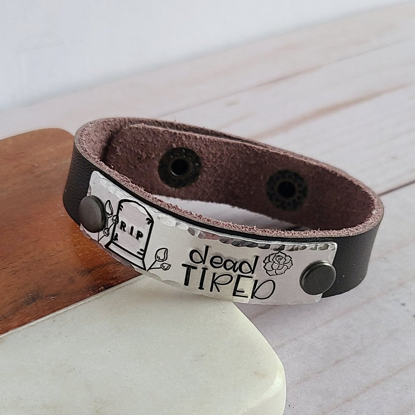 Leather cuff bracelet that reads dead tired