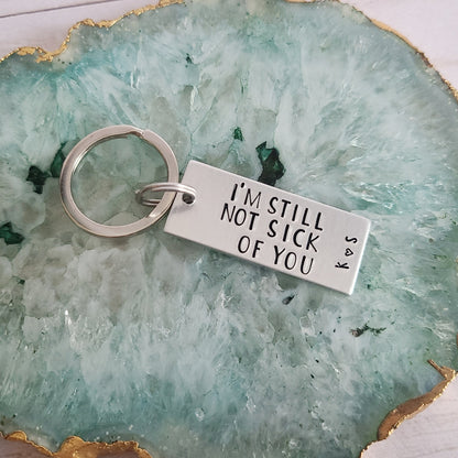 silver metal keychain hand stamped to read I'm Still Not Sick Of You with Initial Heart Initial