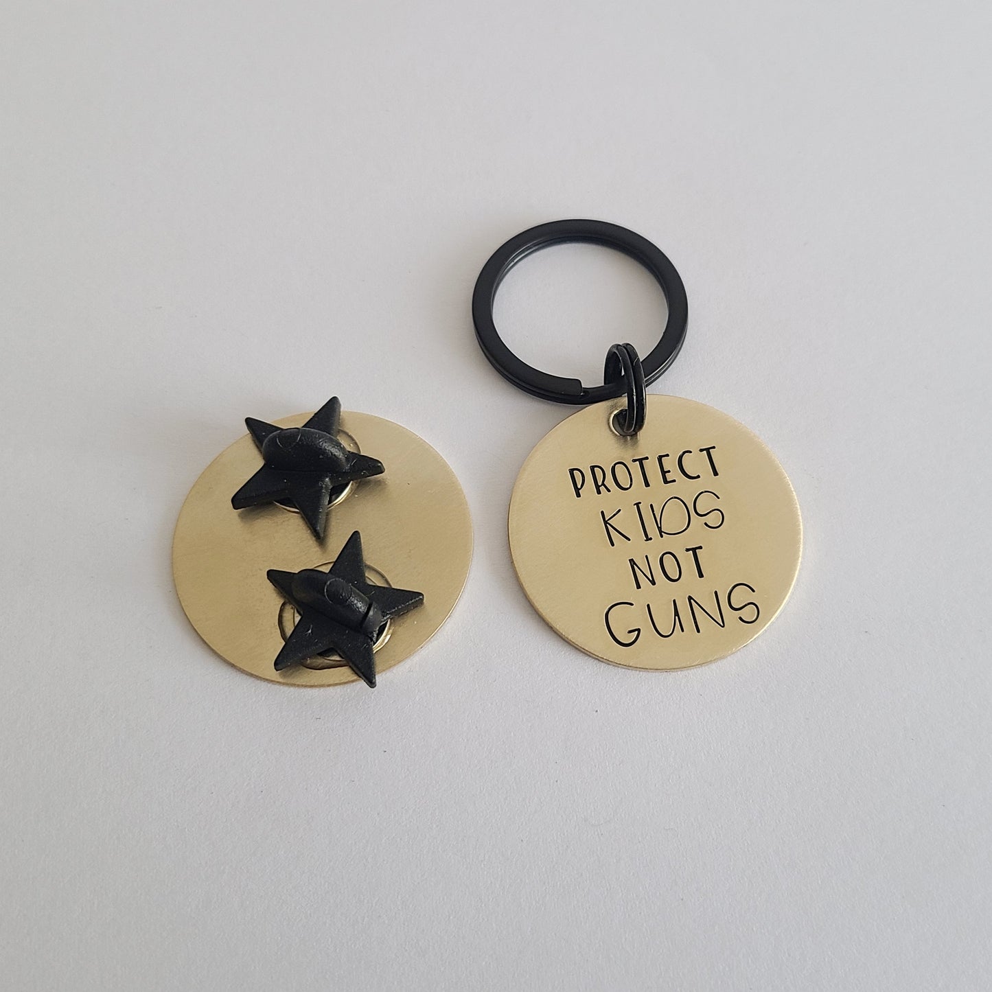 Protect Kids Not Guns Brass Pin or Keychain